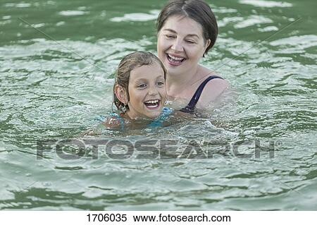 Cheerful grandmother and granddaughter swimming in pool View Large Photo Image Stock Photography - Cheerful grandmother and granddaughter swimming in pool. Fotosearch