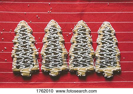 Christmas tree shaped Christmas cookies arranged in a row View Large Photo Image Stock Image - Christmas tree shaped Christmas cookies arranged in a row. Fotosearch