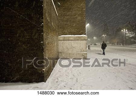 City building and pedestrian in snow storm at night View Large Photo Image Stock Image - City building and pedestrian in snow storm at night. Fotosearch