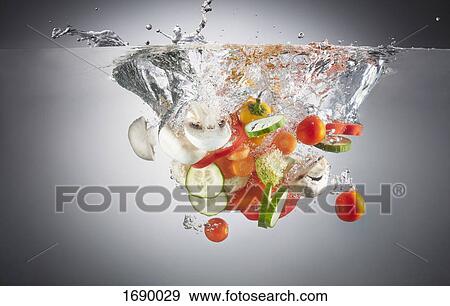 Stock Photo - Close-up of chopped vegetables in splashing water. Fotosearch