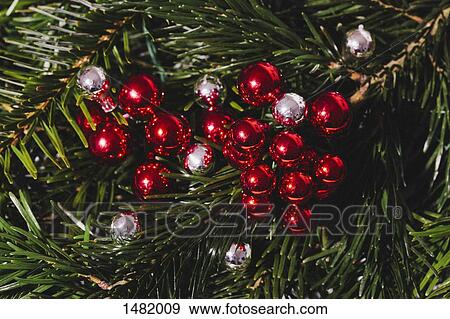 Stock Photo - Close-up of Christmas ornaments hanging on tree. Fotosearch