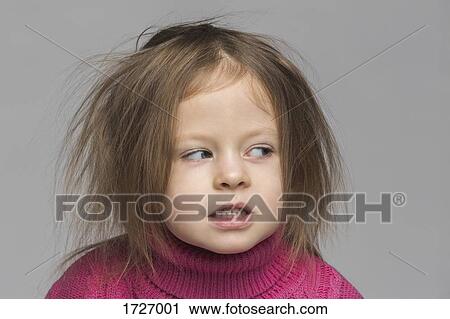 Close-up of cute girl with messy hair looking away against gray background View Large Photo Image Stock Image - Close-up of cute girl with messy hair looking away against gray background. Fotosearch