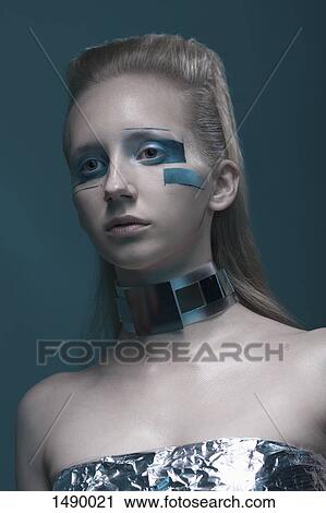 Close-up of fashion model looking away against blue background View Large Photo Image Stock Image - Close-up of fashion model looking away against blue background. Fotosearch