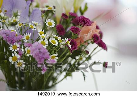 Stock Photo - Close-up of flowers in vase on table. Fotosearch
