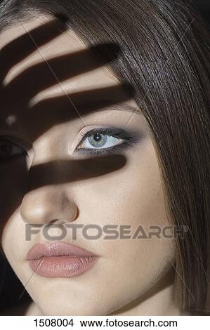 Close-up of hand shadow on woman's face View Large Photo Image Picture - Close-up of hand shadow on woman's face. Fotosearch