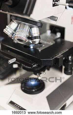 Close-up of microscope at table in laboratory View Large Photo Image Stock Image - Close-up of microscope at table in laboratory. Fotosearch