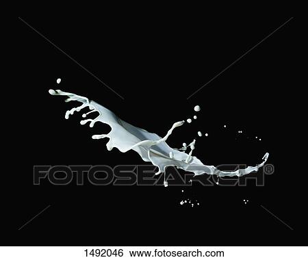 Stock Photograph - Close-up of milk splashing against black background. Fotosearch