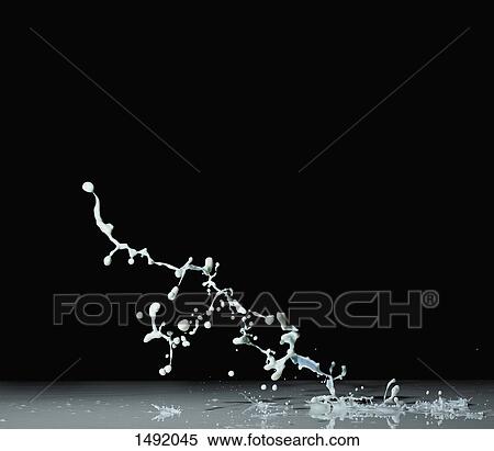Stock Photography - Close-up of milk splashing against black background. Fotosearch