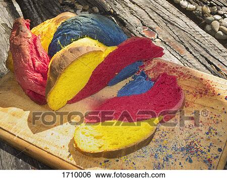 Close-up of multi colored bread on cutting board View Large Photo Image Stock Photograph - Close-up of multi colored bread on cutting board. Fotosearch