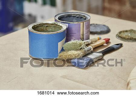 Close-up of paint cans and paintbrushes on workbench View Large Photo Image Picture - Close-up of paint cans and paintbrushes on workbench. Fotosearch