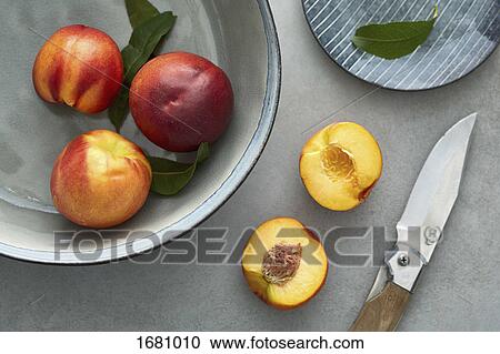 Close-up of peaches on table and container View Large Photo Image Stock Image - Close-up of peaches on table and container. Fotosearch