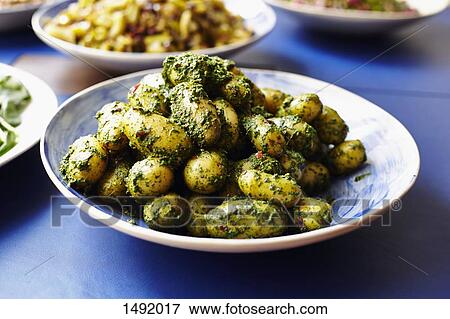 Stock Photo - Close-up of prepared potatoes served in plate at table. Fotosearch