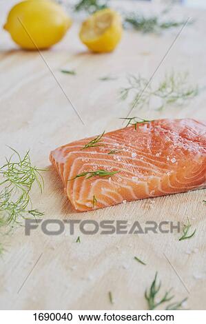 Close-up of seasoned salmon slice and rosemary on table View Large Photo Image Stock Image - Close-up of seasoned salmon slice and rosemary on table. Fotosearch
