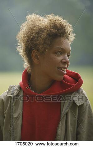 Close-up of smiling mid adult woman with curly hair looking away at park View Large Photo Image Stock Image - Close-up of smiling mid adult woman with curly hair looking away at park. Fotosearch