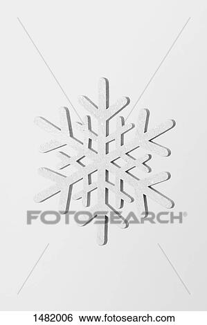 Close-up of snowflake against white background View Large Photo Image Stock Photograph - Close-up of snowflake against white background. Fotosearch