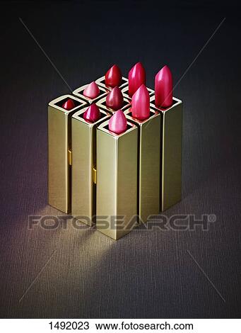 Stock Image - Close-up of various pink lipsticks on table. Fotosearch