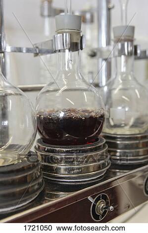 Stock Image - Close-up of wine boiling in flask at laboratory. Fotosearch