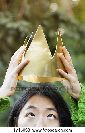 Close-up of woman wearing paper crown at park View Large Photo Image Stock Image - Close-up of woman wearing paper crown at park. Fotosearch