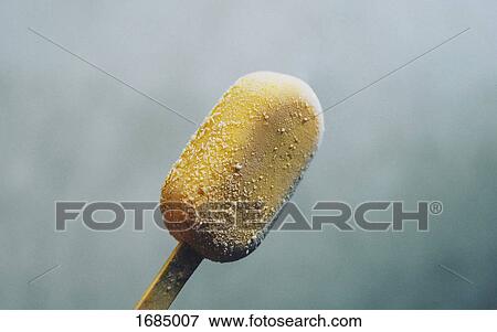 Close-up of yellow ice cream on stick View Large Photo Image Stock Photo - Close-up of yellow ice cream on stick. Fotosearch