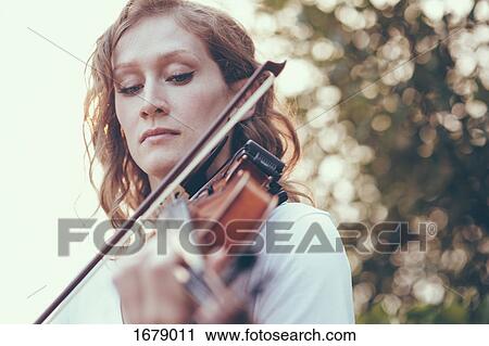 Close-up of young woman playing violin View Large Photo Image Stock Image - Close-up of young woman playing violin. Fotosearch