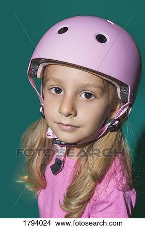 Picture - Close up portrait confident girl wearing pink helmet. Fotosearch