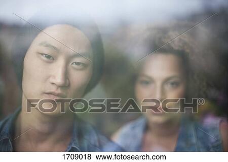 Close-up portrait of couple seen through glass window View Large Photo Image Stock Photo - Close-up portrait of couple seen through glass window. Fotosearch