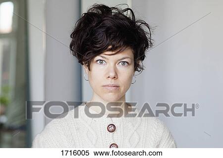 Close-up portrait of frowning woman with short hair against wall View Large Photo Image Stock Photography - Close-up portrait of frowning woman with short hair against wall. Fotosearch