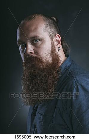 Stock Photography - Close-up portrait of hipster against gray background. Fotosearch