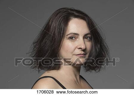 Close-up portrait of mature woman with short hair against gray background View Large Photo Image Stock Photo - Close-up portrait of mature woman with short hair against gray background. Fotosearch