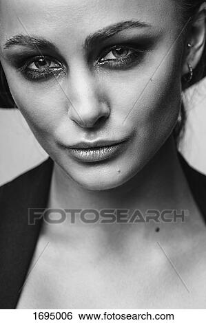 Close-up portrait of smiling young woman View Large Photo Image Stock Photograph - Close-up portrait of smiling young woman. Fotosearch