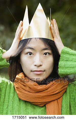 Close-up portrait of woman wearing paper crown at park View Large Photo Image Stock Image - Close-up portrait of woman wearing paper crown at park. Fotosearch