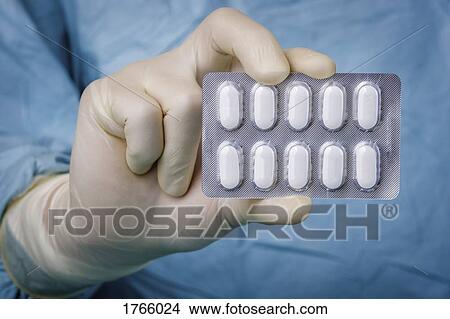 Close up scientist holding blister pack of pills View Large Photo Image Picture - Close up scientist holding blister pack of pills. Fotosearch