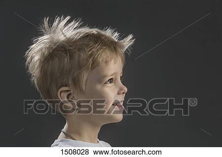 Close-up side view of happy boy against gray background View Large Photo Image Stock Photo - Close-up side view of happy boy against gray background. Fotosearch