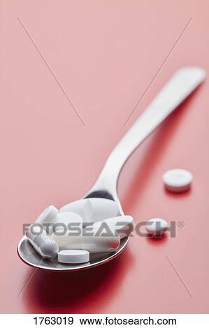 Close up spoon of pills on pink background View Large Photo Image Stock Photo - Close up spoon of pills on pink background. Fotosearch