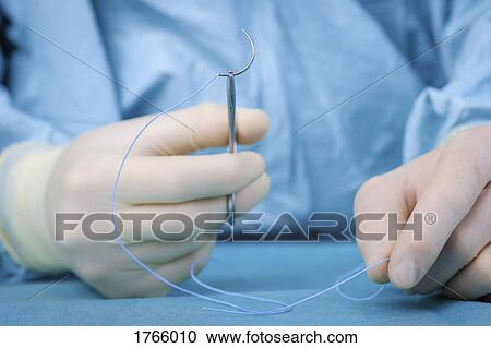 Close up surgeon holding needle View Large Photo Image Stock Image - Close up surgeon holding needle. Fotosearch