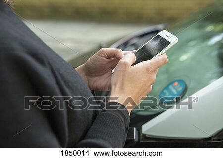 Close up woman using smart phone to access car share View Large Photo Image Picture - Close up woman using smart phone to access car share. Fotosearch