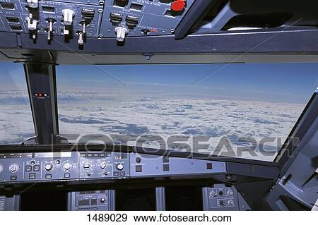 Cloudy sky seen through of airplane windshield View Large Photo Image Stock Photo - Cloudy sky seen through of airplane windshield. Fotosearch
