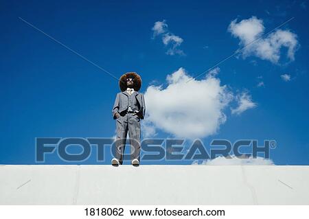 Confident, cool, well-dressed young man with afro standing on sunny wall against blue sky View Large Photo Image Stock Image - Confident, cool, well-dressed young man with afro standing on sunny wall against blue sky. Fotosearch