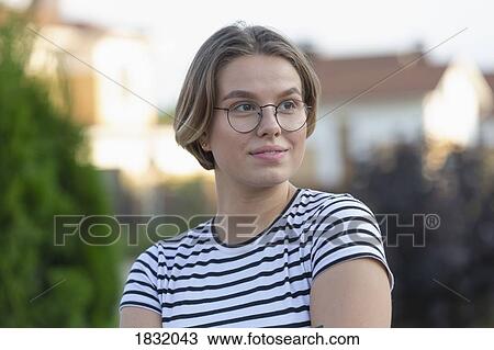 Stock Image - Confident young woman looking away. Fotosearch