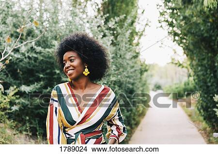 Confident young woman on path in park View Large Photo Image Picture - Confident young woman on path in park. Fotosearch
