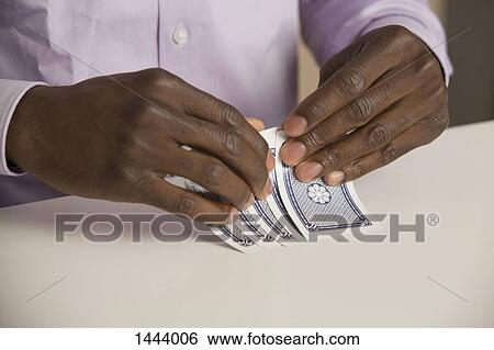 Cropped hands playing cards at table View Large Photo Image Stock Photograph - Cropped hands playing cards at table. Fotosearch