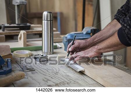 Cropped image of male carpenter marking on wood in workshop View Large Photo Image Stock Photograph - Cropped image of male carpenter marking on wood in workshop. Fotosearch