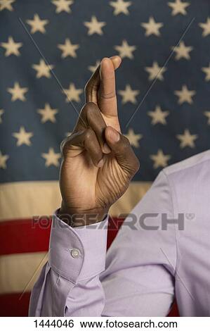 Cropped image of man crossing fingers against American flag View Large Photo Image Stock Photograph - Cropped image of man crossing fingers against American flag. Fotosearch