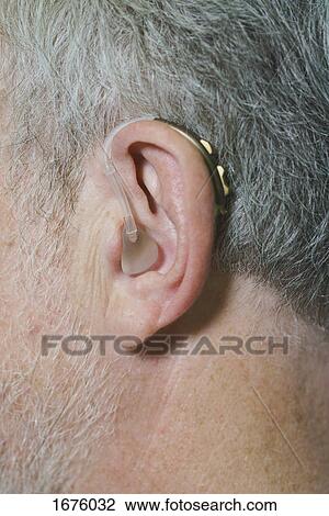 Cropped image of man wearing hearing aid View Large Photo Image Stock Image - Cropped image of man wearing hearing aid. Fotosearch