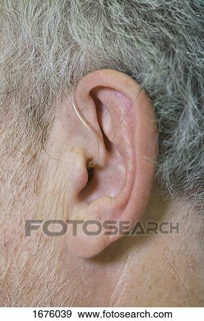 Cropped image of man wearing hearing aid View Large Photo Image Stock Photo - Cropped image of man wearing hearing aid. Fotosearch