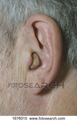 Cropped image of mature man wearing hearing aid View Large Photo Image Stock Photography - Cropped image of mature man wearing hearing aid. Fotosearch