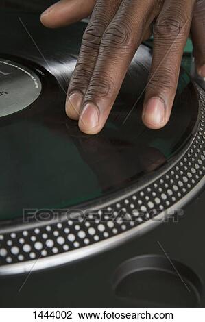 Cropped view of hand of DJ scratching record View Large Photo Image Stock Image - Cropped view of hand of DJ scratching record. Fotosearch