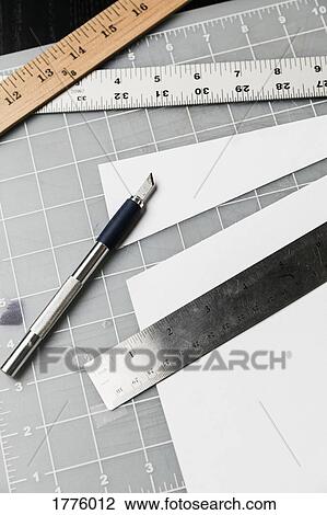 Cutter and rulers on cutting mat View Large Photo Image Stock Image - Cutter and rulers on cutting mat. Fotosearch