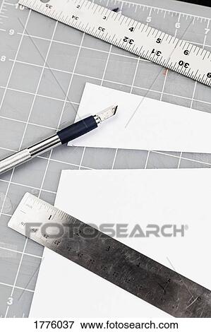 Cutter and rulers on cutting mat View Large Photo Image Stock Photo - Cutter and rulers on cutting mat. Fotosearch