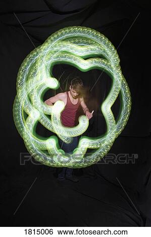 Dancer performing with light sticks View Large Photo Image Stock Photograph - Dancer performing with light sticks. Fotosearch